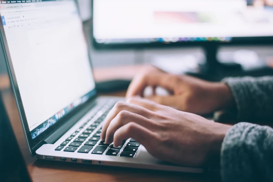 Person working on a laptop in a focused workspace